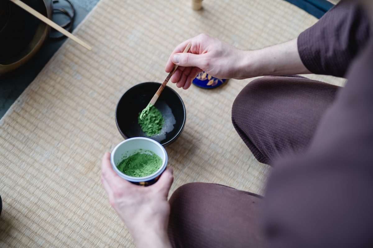 Matcha Powder in the ceramic natsume, scooping 3 scoops into the chawan teabowl